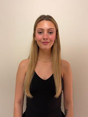 white woman with long blonde hair wearing a black dress